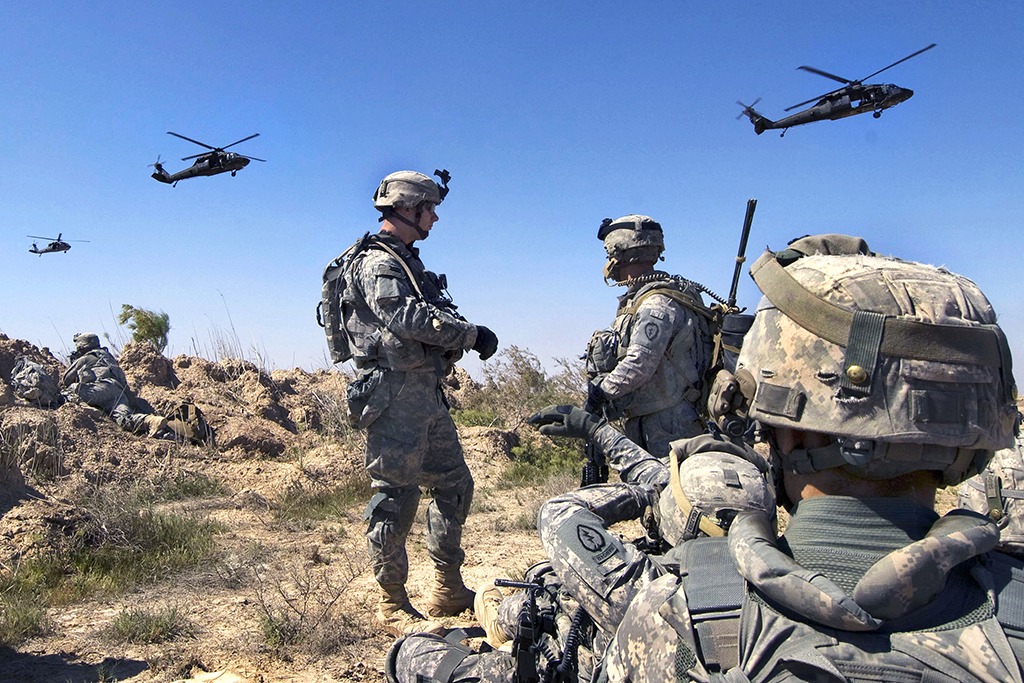 U.S. Soldiers wait to be picked up by helicopters south of Balad Ruz, Iraq, March 22, 2009. The Soldiers are assigned to Recon Platoon, 1st Battalion, 24th Infantry Regiment, 1st Stryker Brigade Combat Team, 25th Infantry Division. (DoD photo by Mass Communication Specialist 2nd Class Walter J. Pels, U.S. Navy/Released)